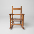 Children's solid oak wooden rocking chair with slatted backrest in a nursery setting